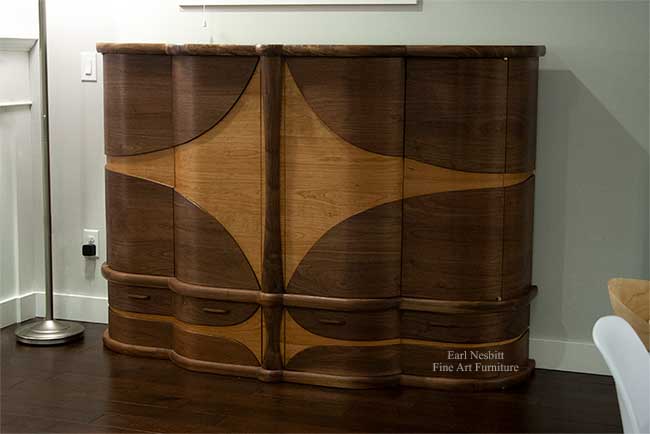 art deco bar cabinet emphasizing curved design from other side with all doors and drawers closed